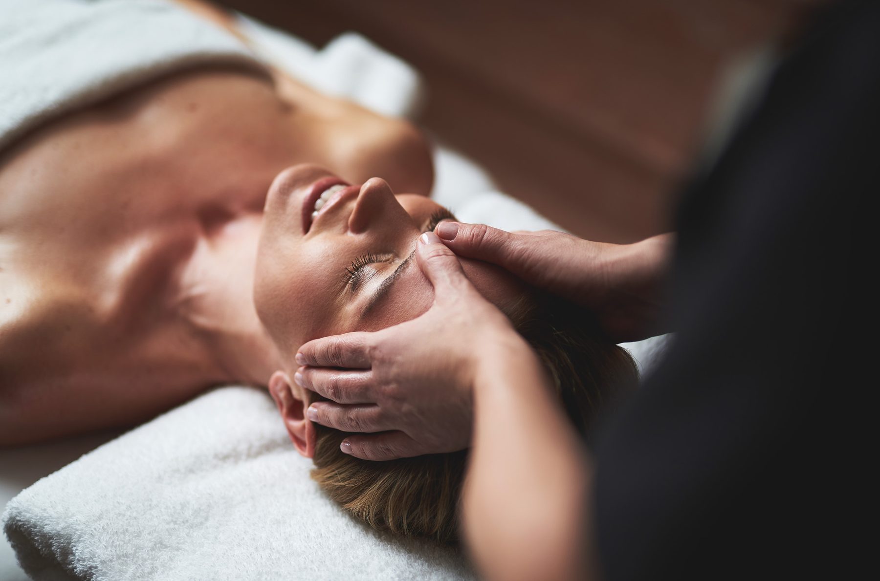 Esthetician performing a dermaplaning treatment near the brow in Orlando
